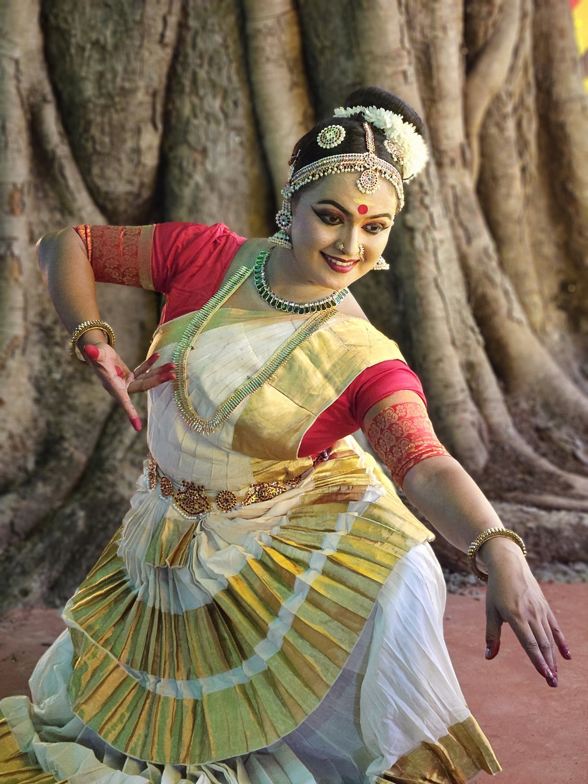 Dr. Devi Manjula in a graceful outdoor dance pose